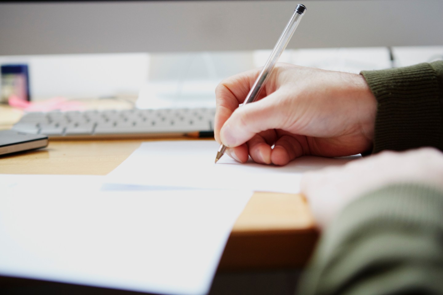 Man writing on paper with pen