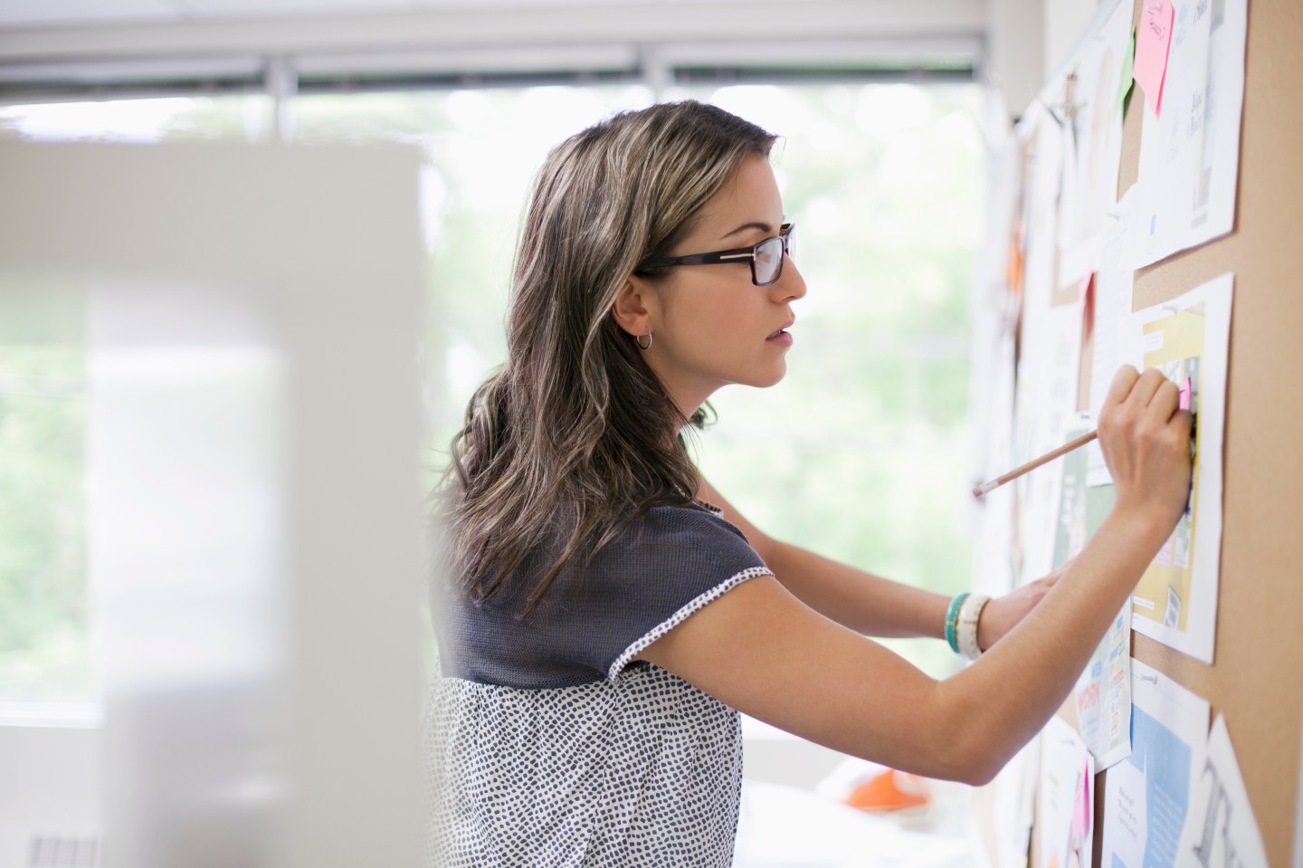 designer making notations on proofs