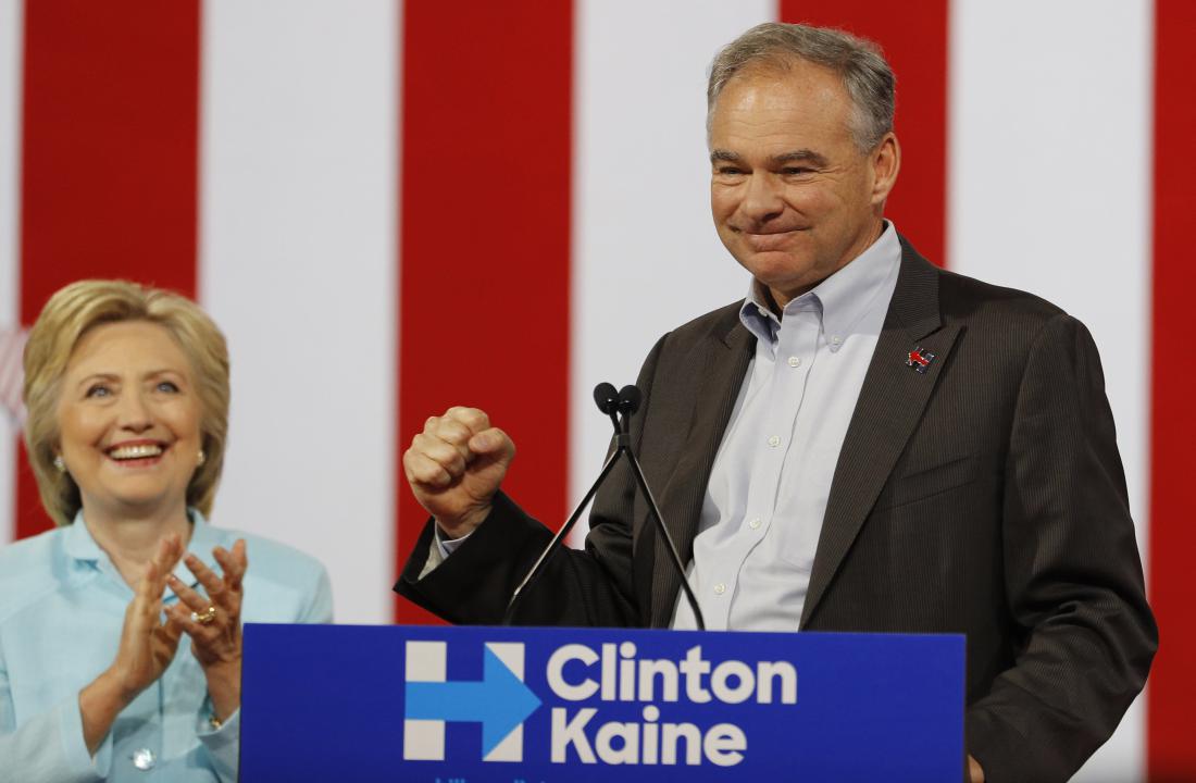 Democratic U.S. presidential candidate Clinton listens to her running-mate Democratic U.S. vice presidential candidate Kaine after she introduced him during a campaign rally in Miami