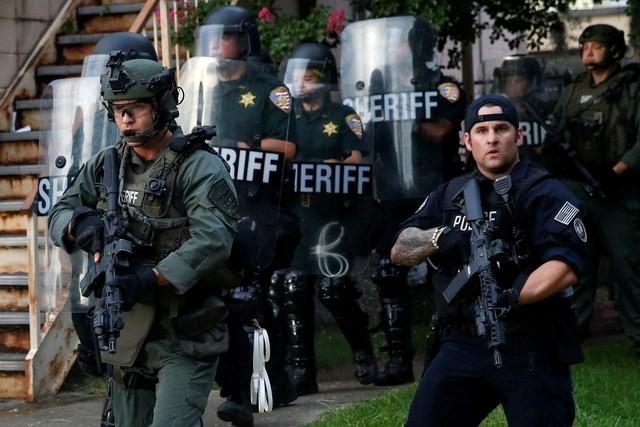File photo of law officers marching down a street during protests in Baton Rouge