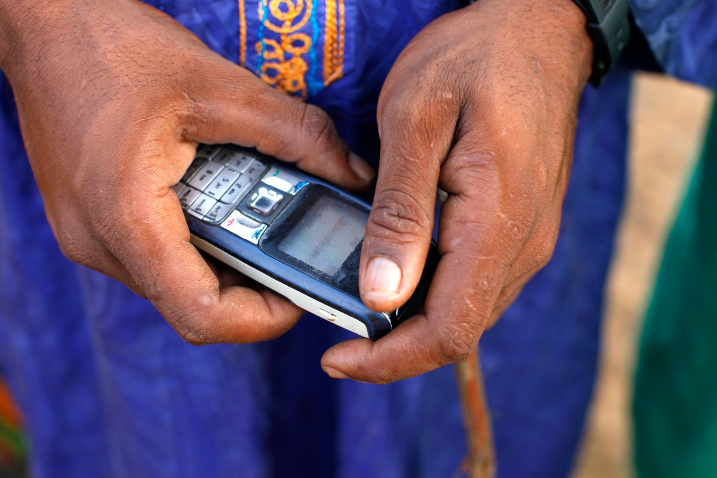 Peul farmer using a cell phone