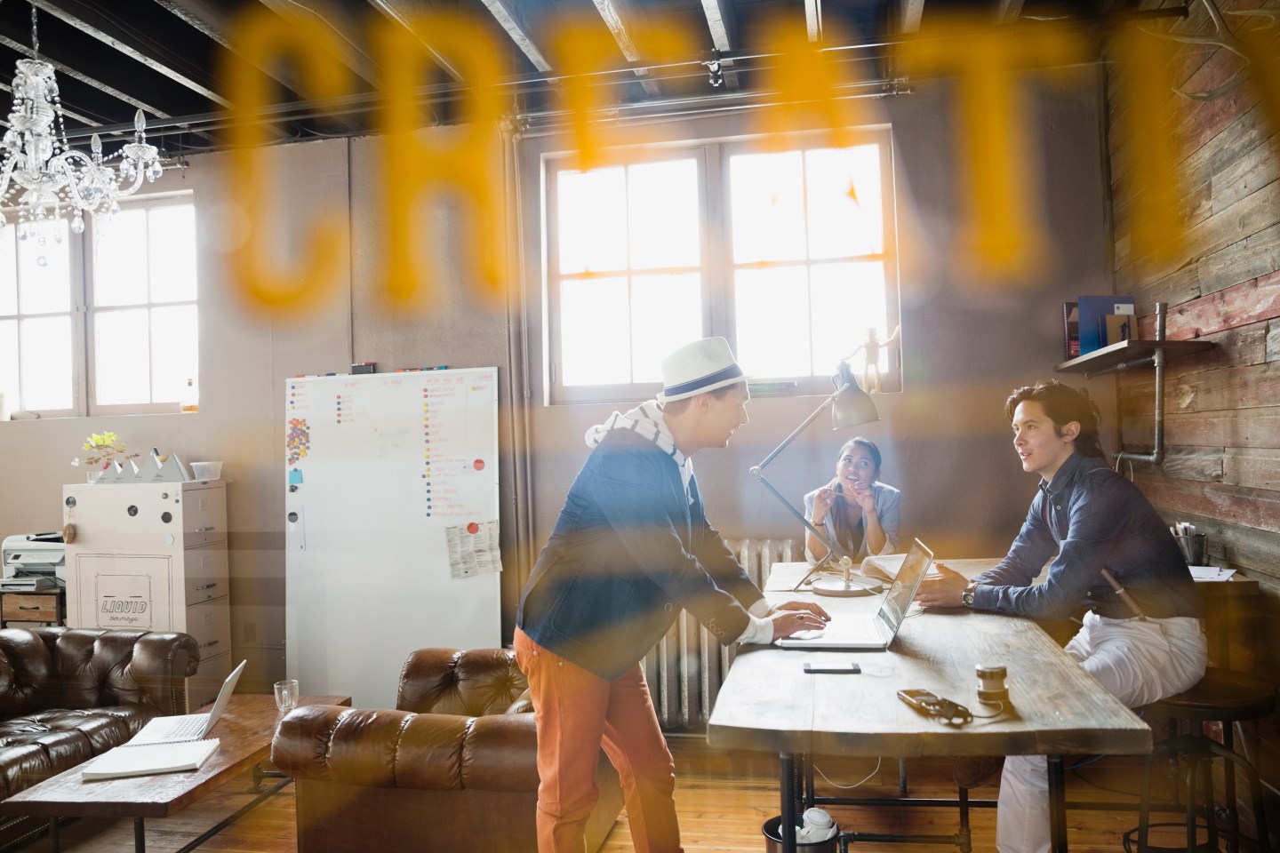 View through door of entrepreneurs working in office