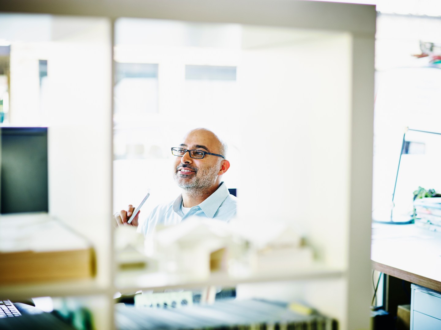 Smiling small business owner sitting in office