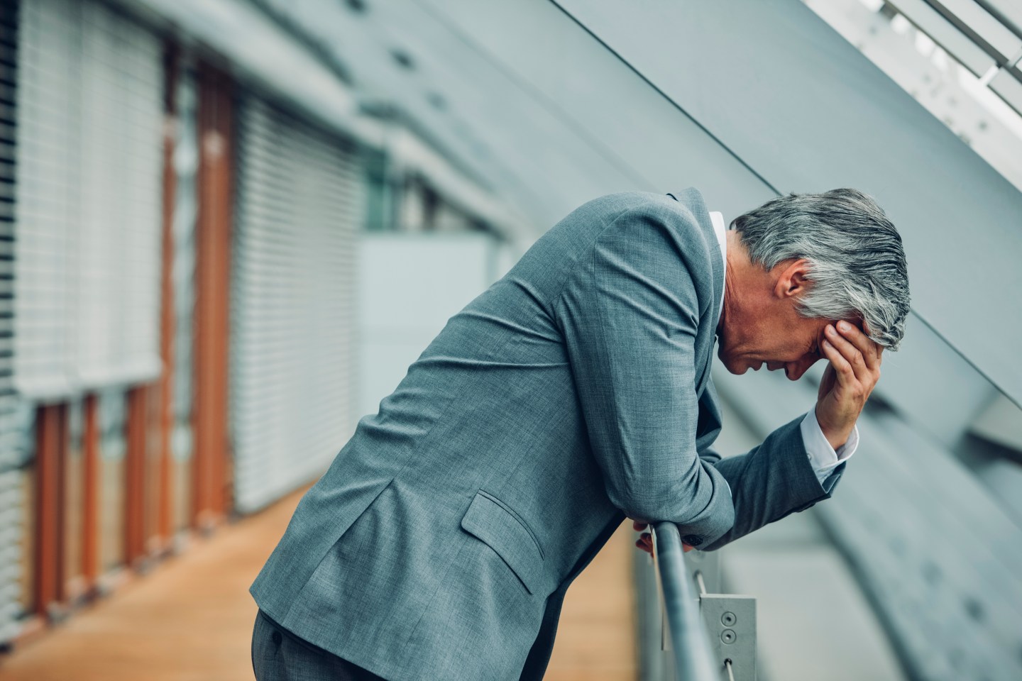 Desperate businessman leaning on railing