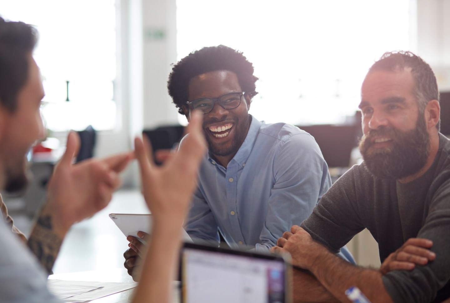 Co-workers laughing together at meeting