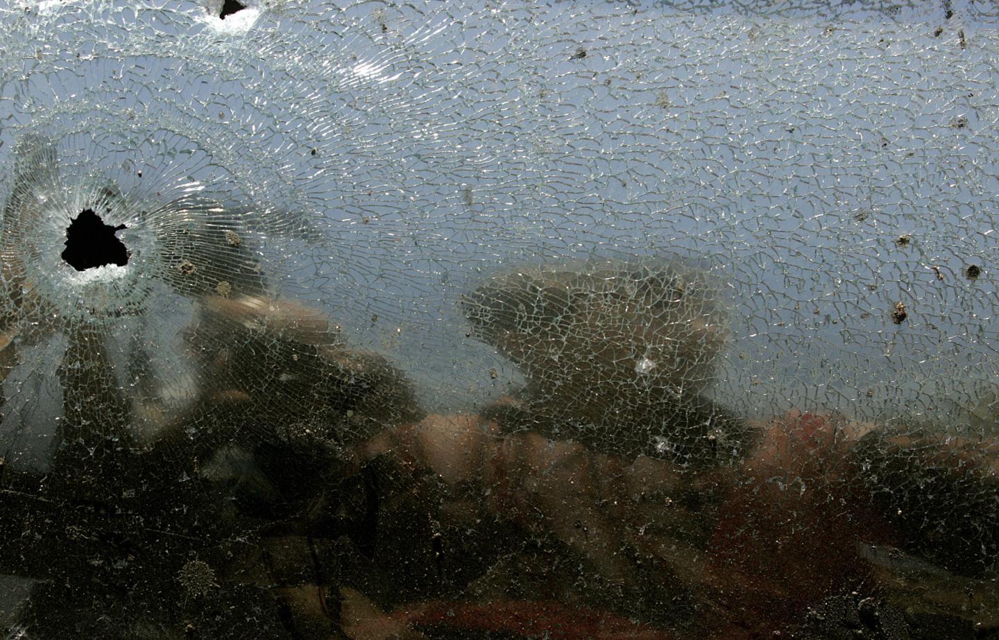 An Iraqi soldier is reflected on broken