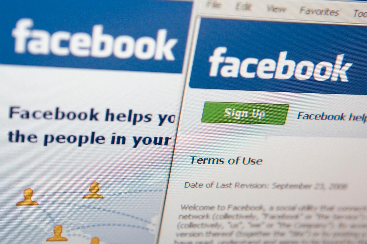 The Facebook terms of use are displayed on a computer monito