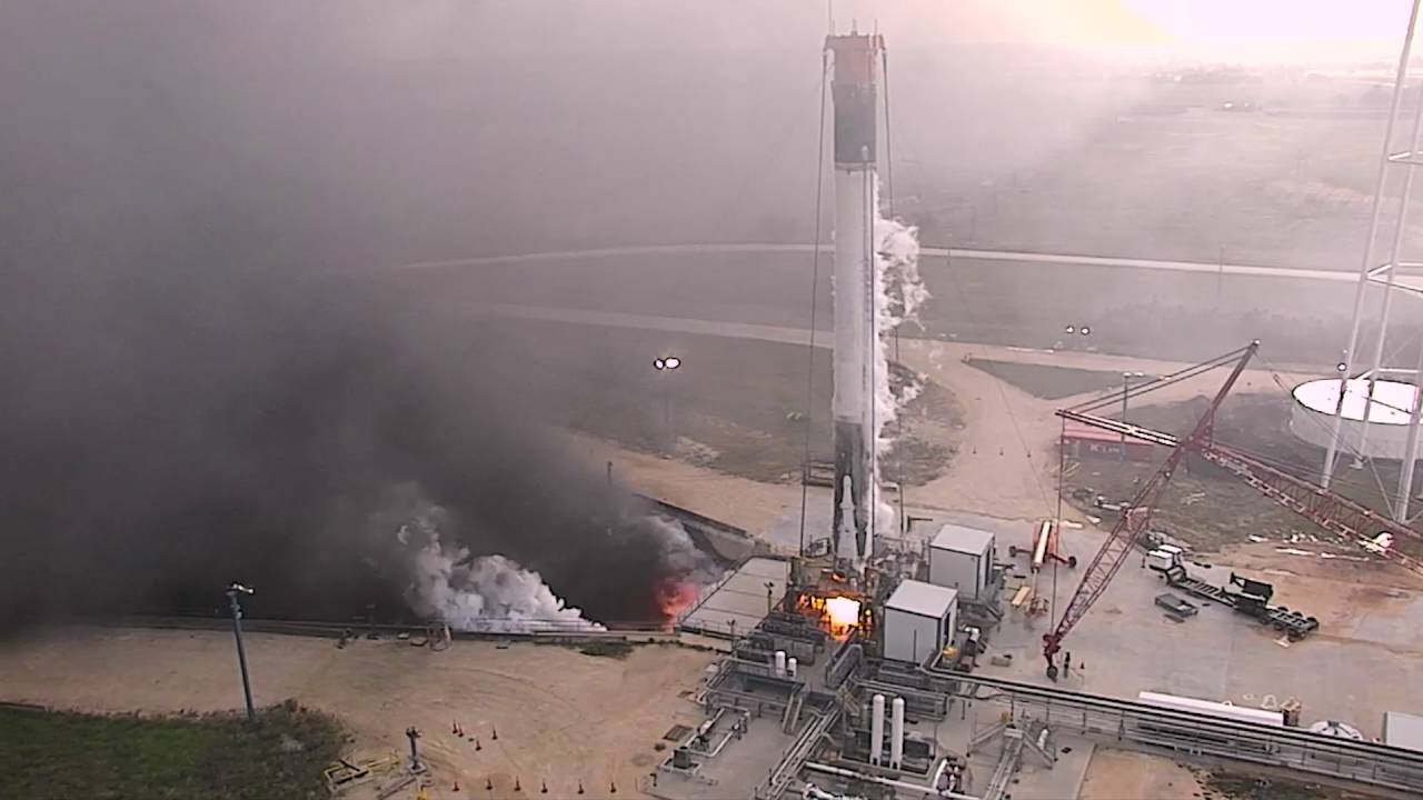 spacex rocket firing on landing pad