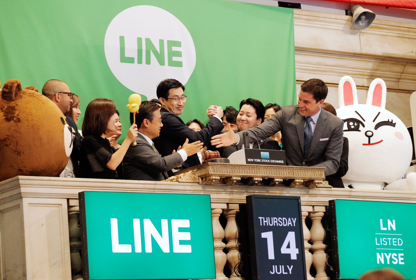 NYSE president Tom Farley congratulates Japan's Line Corp. CFO In-Joon Hwang and Chief Global Officer Joongho Shin and Chief Strategy and Marketing Officer Jun Masuda during the company's IPO on the floor of the New York Stock Exchange