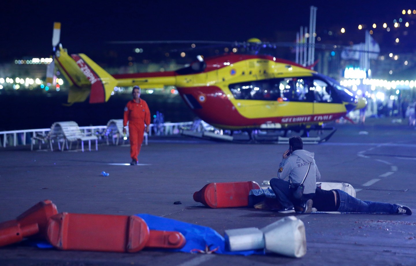 An injured individual is seen on the ground after at least 30 people were killed in the southern French town of Nice when a truck ran into a crowd celebrating the Bastille Day national holiday