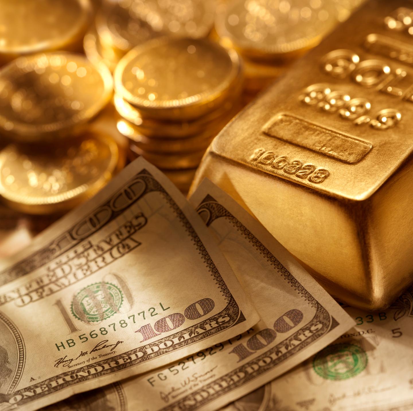 Hundred dollar bills surrounded by gold