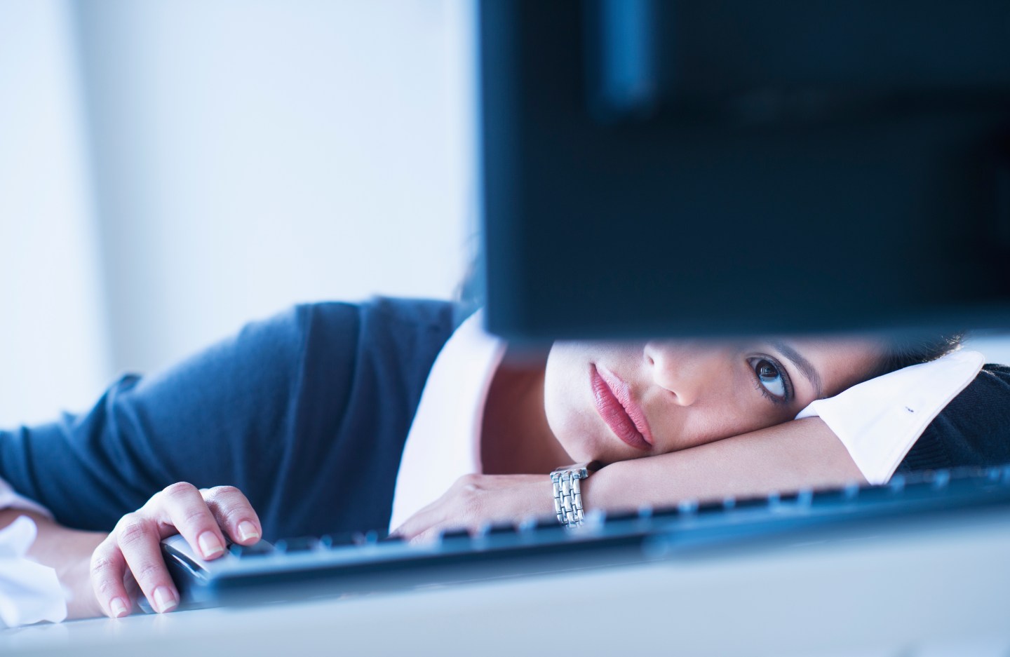 USA, New Jersey, Jersey City, Businesswoman looking tired in front of computer