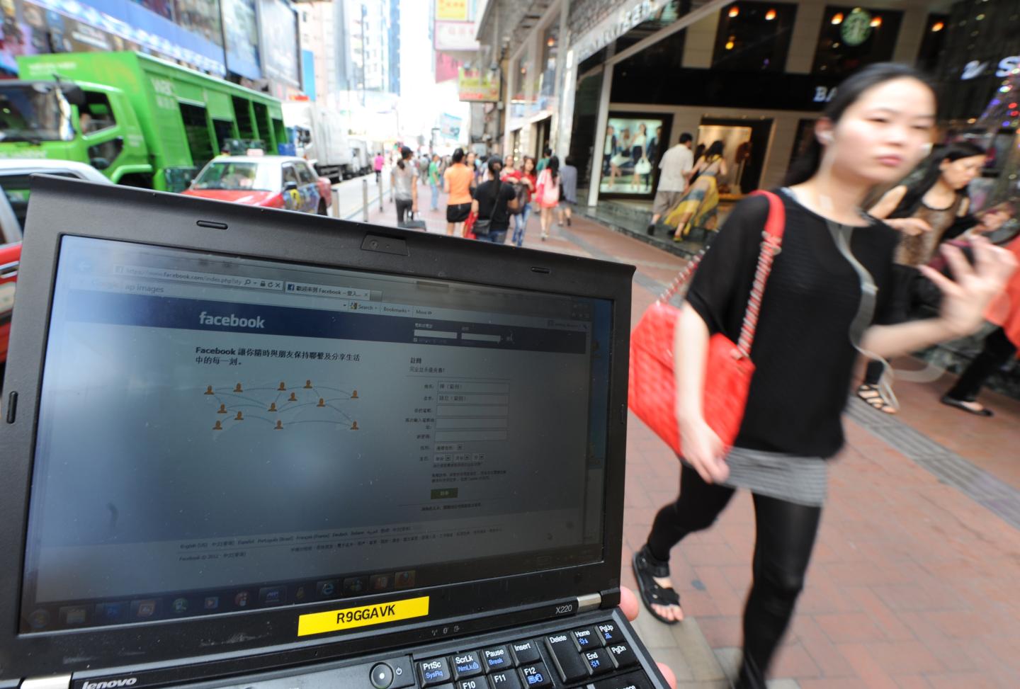 A pedestrian walks past a computer showi
