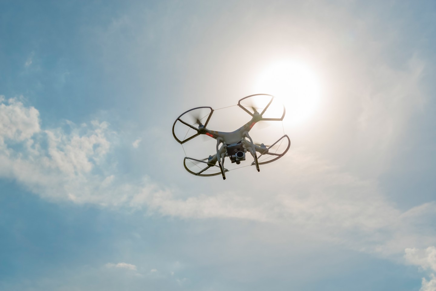 DJI white drone flying. These unmanned aerial vehicles are