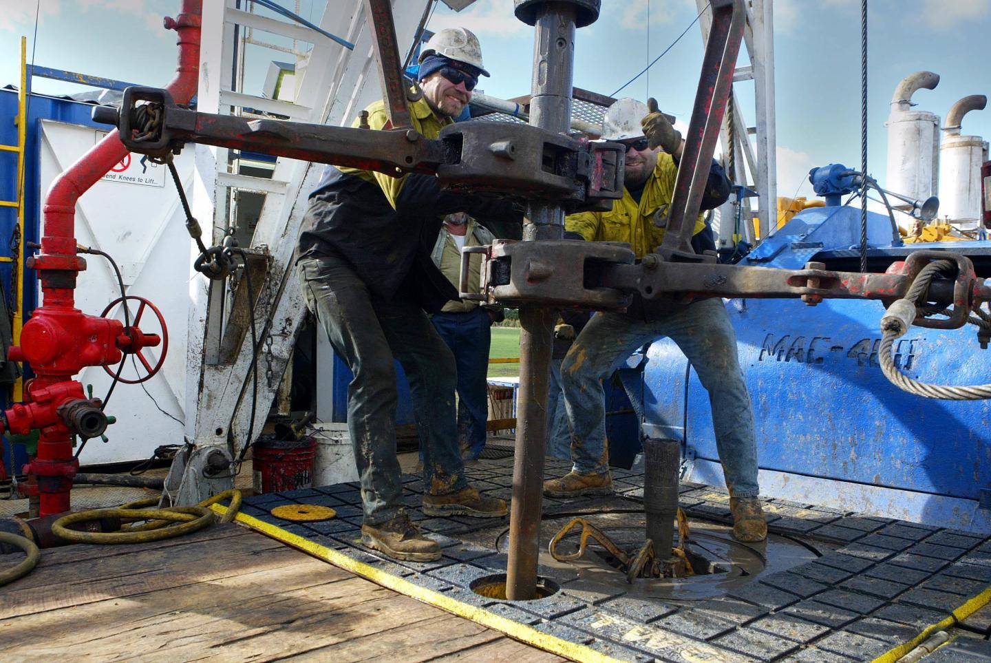 Workers change out a pipe on The Bellarine 1 drilling rig west of Geelong. The