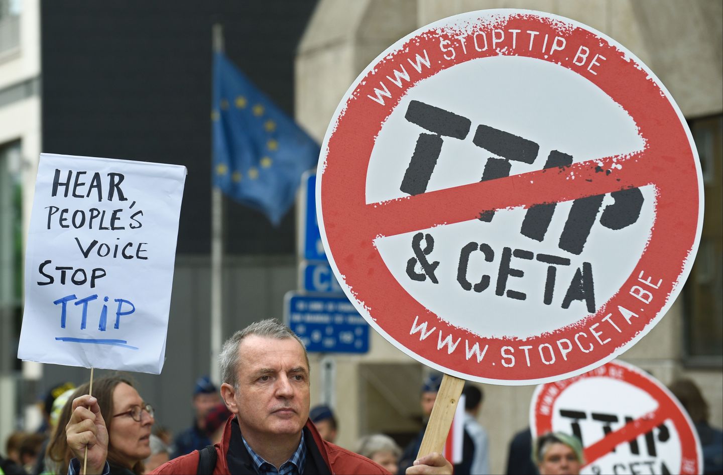 Activists hold banners during a protest against the Transatlantic Trade and Investment Partnership (TTIP) in front of the EU commission building in Brussels.