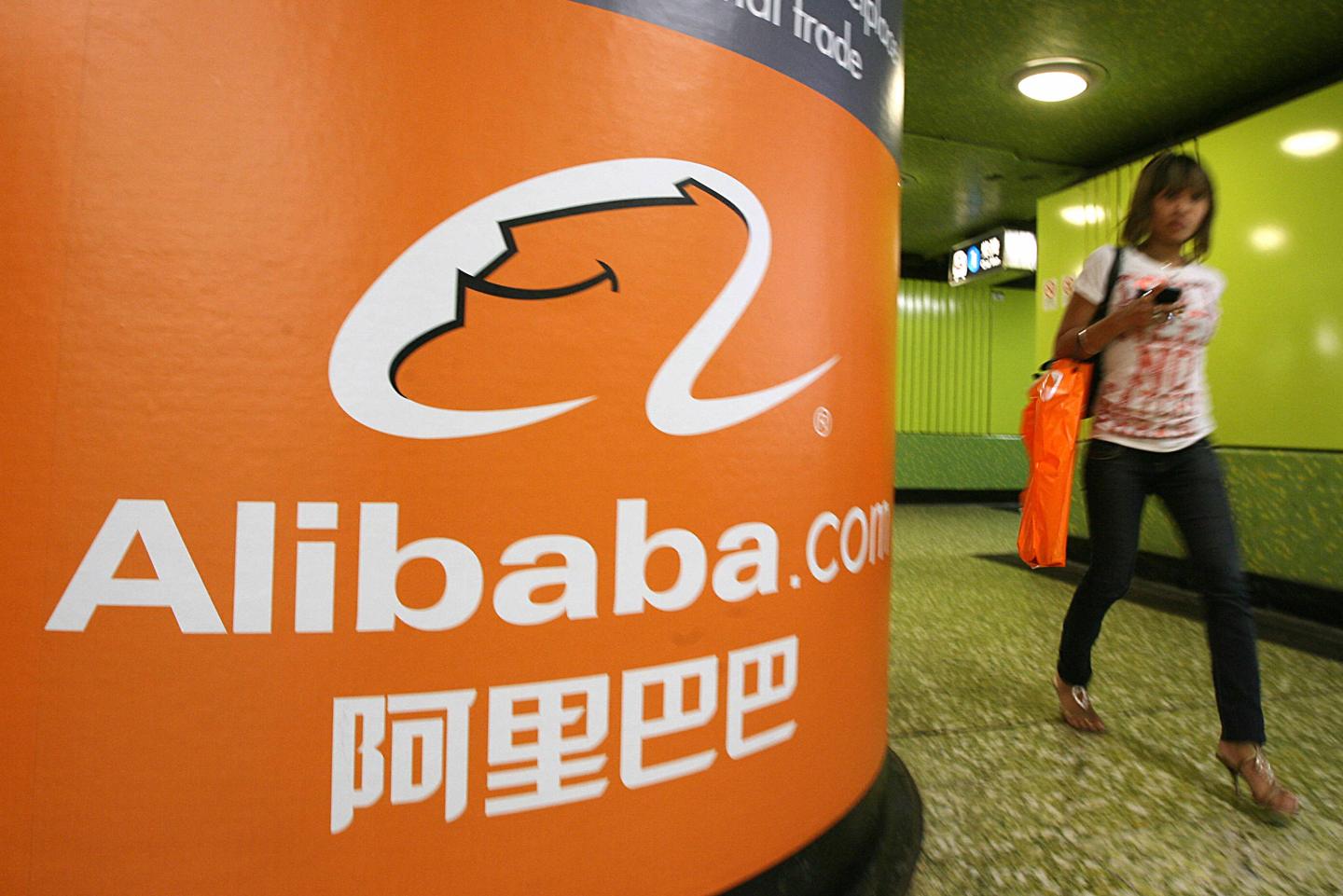 A pedestrian walks past Alibaba.com adve