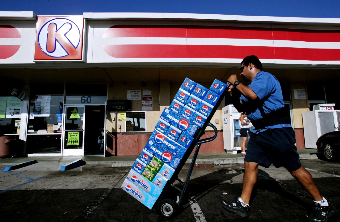 A vendor carts Pepsi products into a Circle K store in Chula