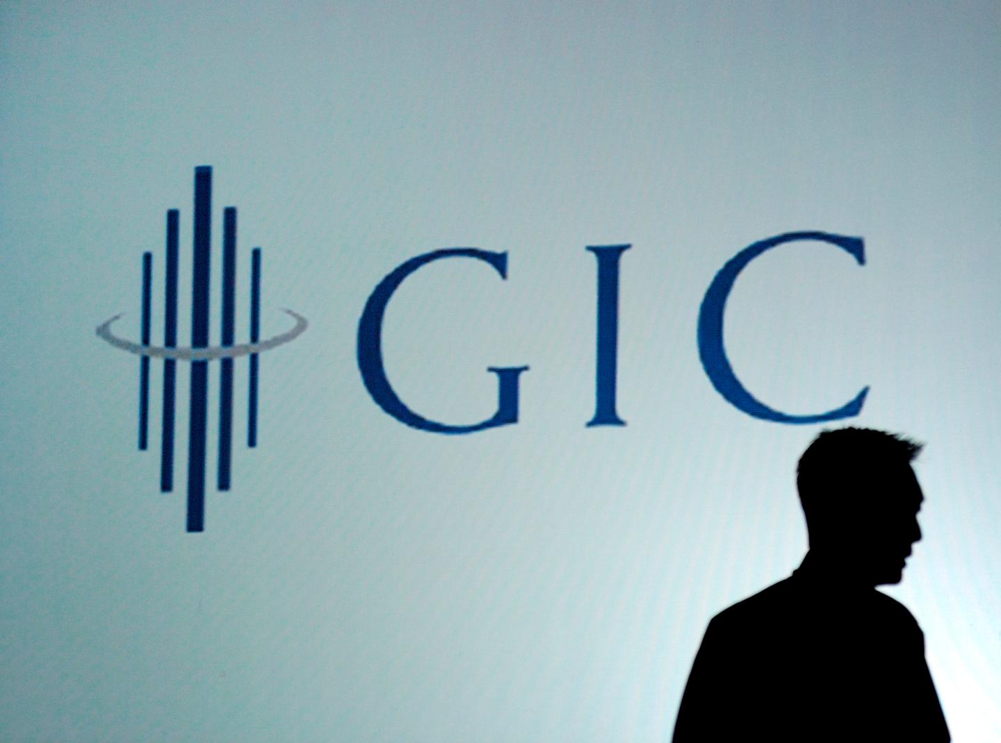 An employee is silhouetted against the logo for the Governme