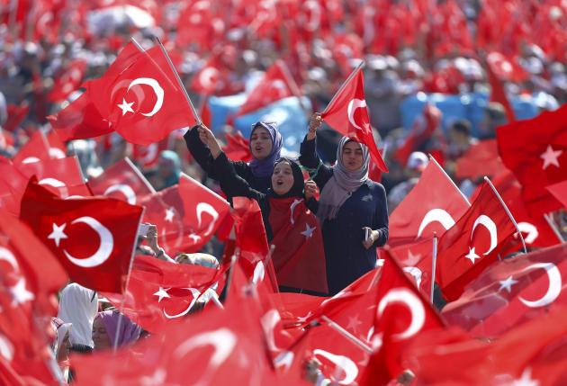 People wave Turkey's national flags during the Democracy and Martyrs Rally in Istanbul