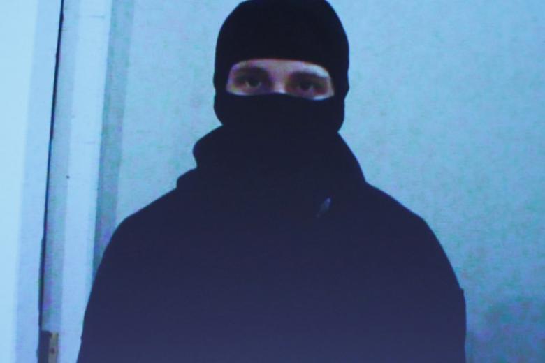 A video of Aaron Driver is projected on a screen during a news conference in Ottawa