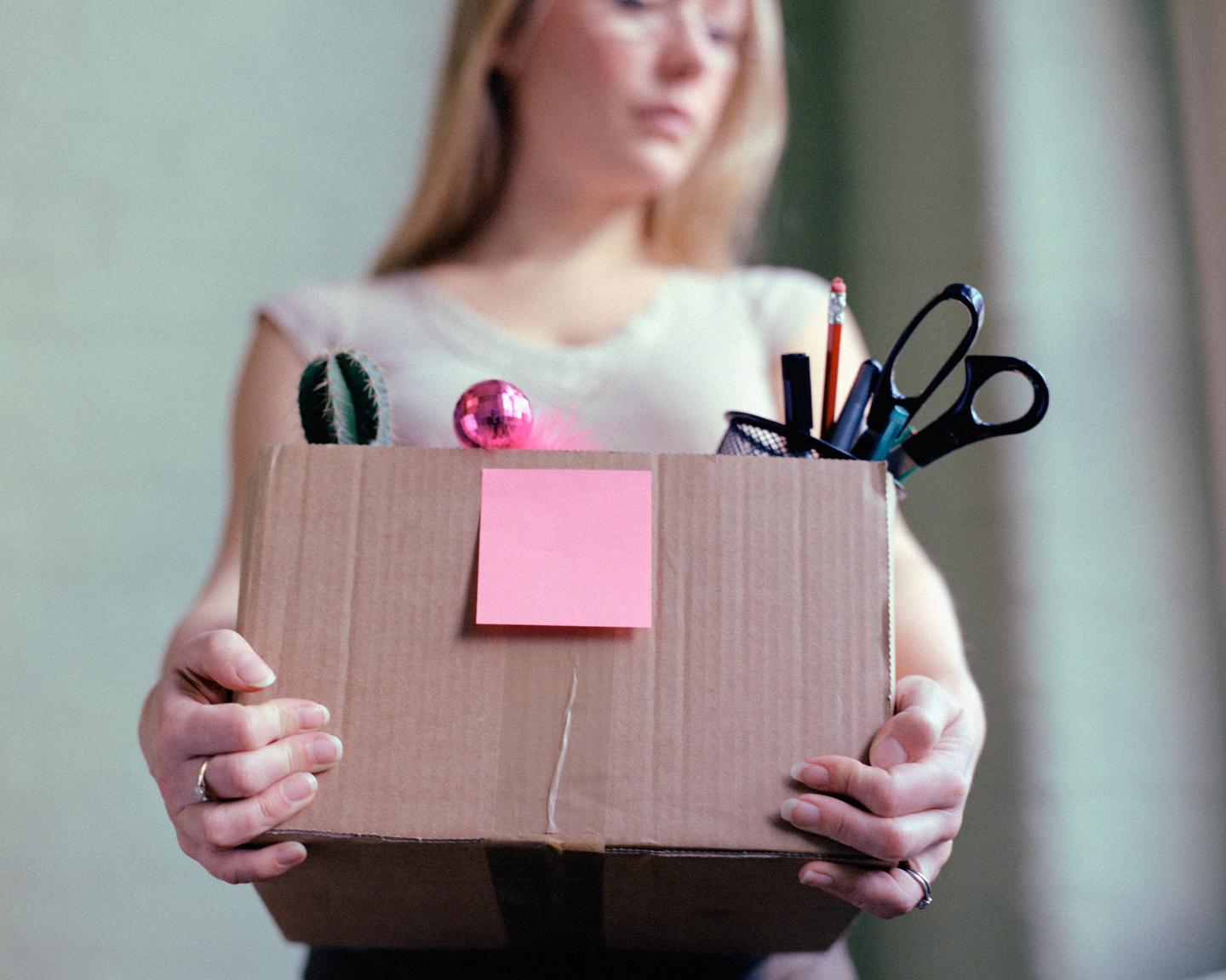 Woman carrying box of stationery