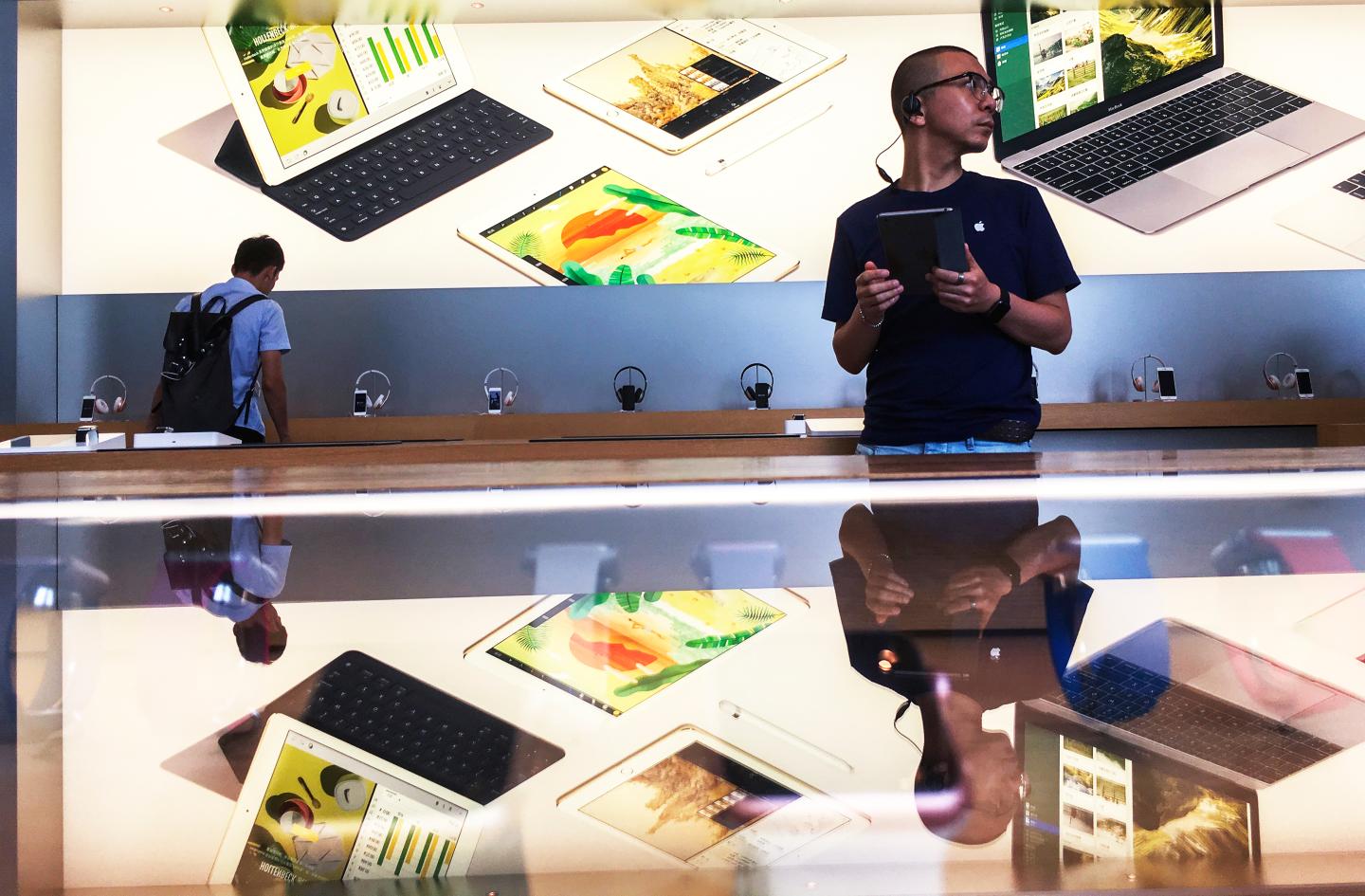 Customers in an Apple shop in Beijing Dawanglu CBD.  As