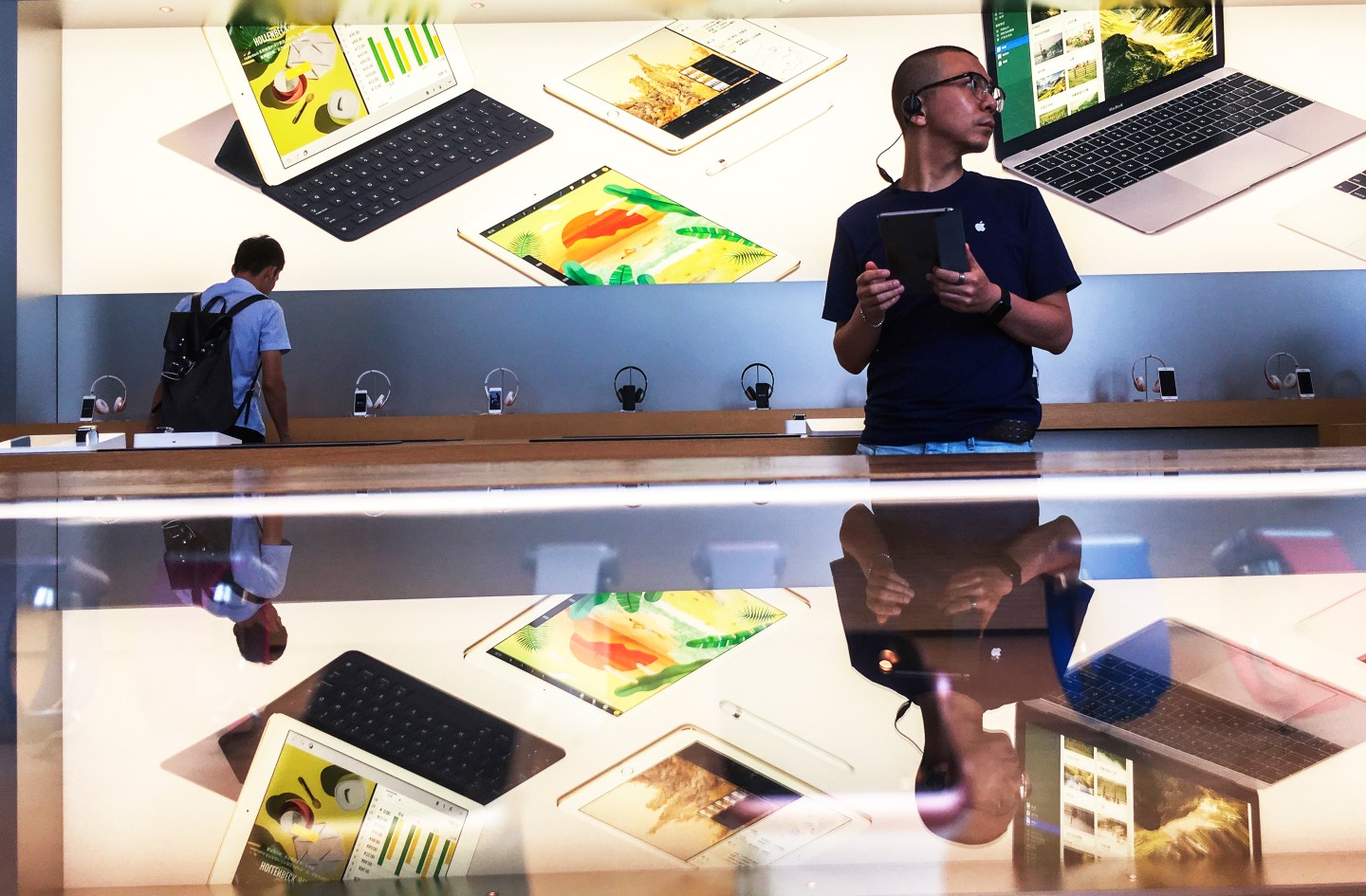 Customers in an Apple shop in Beijing Dawanglu CBD. As