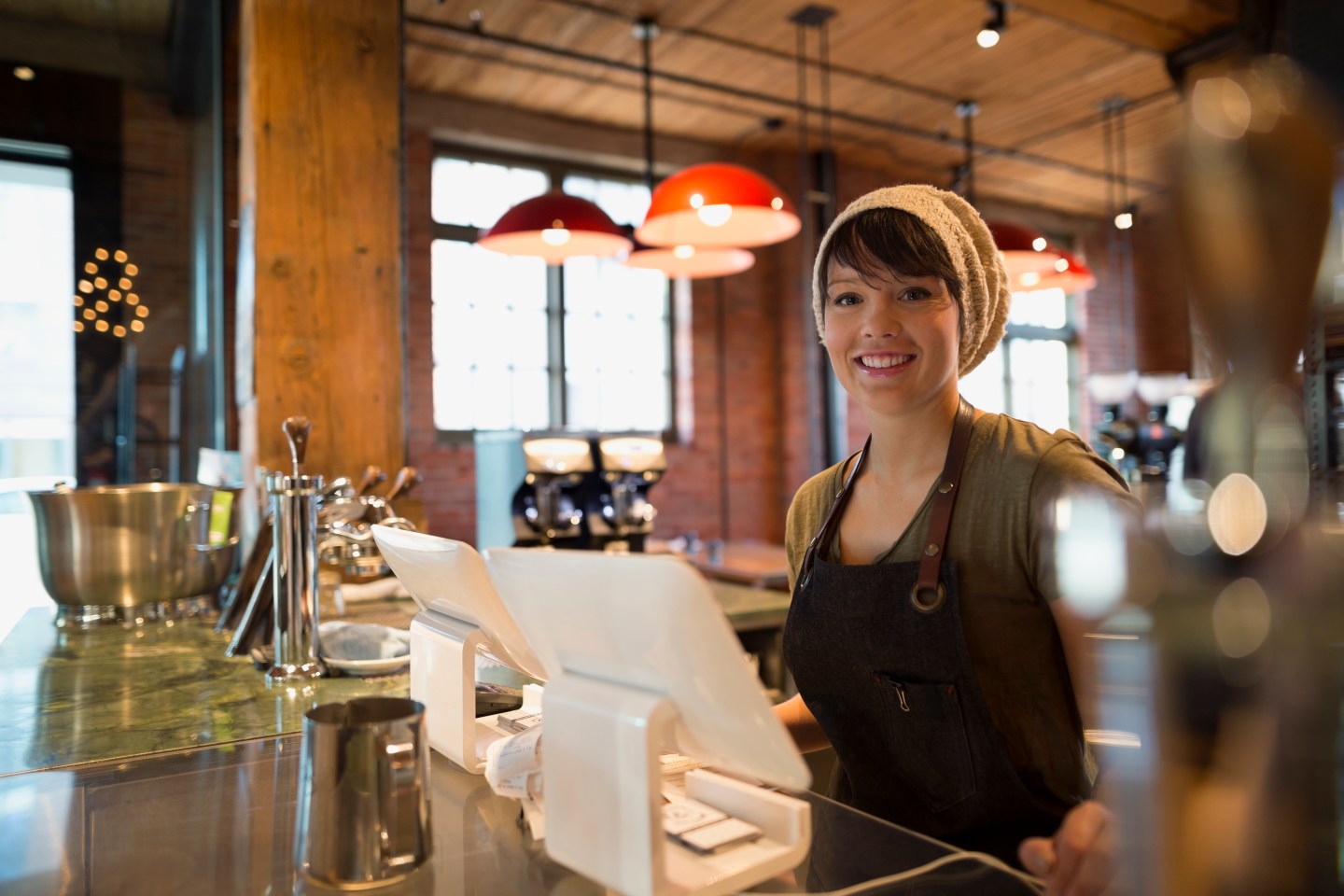 Portrait smiling barista in coffee shop