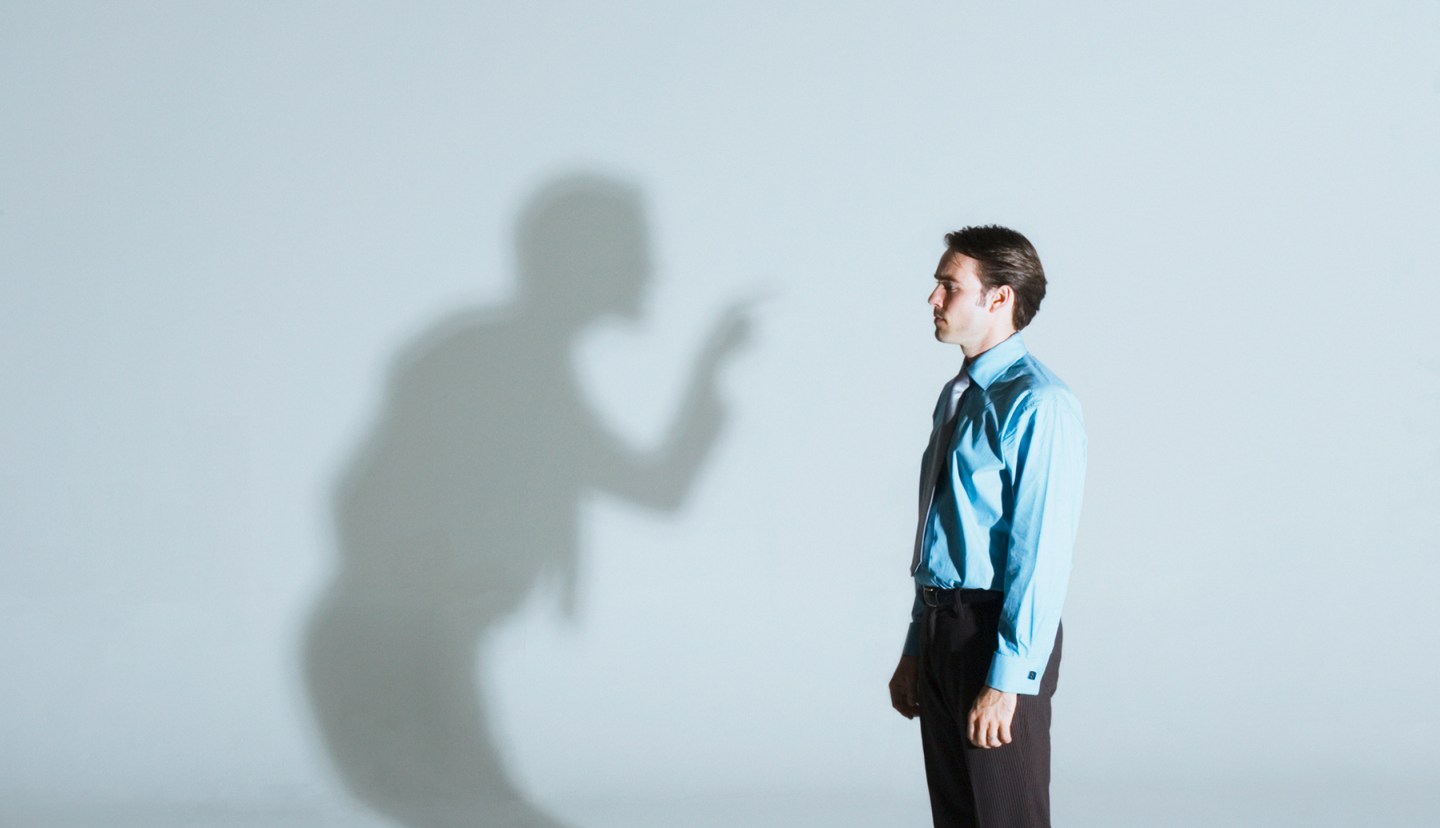 Man being scolded by his shadow