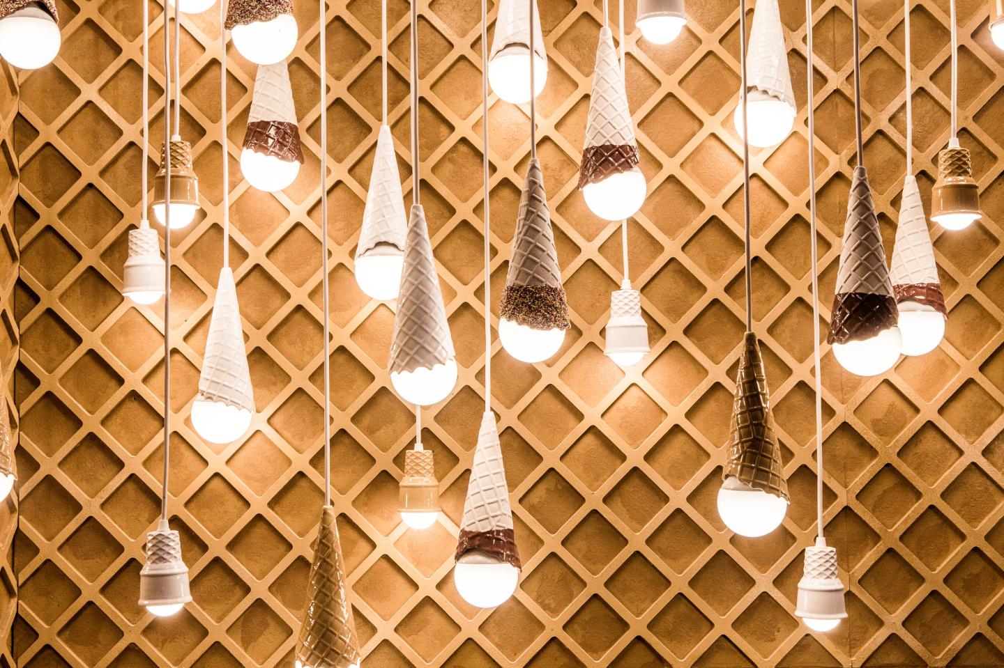 Dangling light fixtures created by artist Alex Garnett in a room dedicated to ice cream cones during a press preview of the Museum of Ice Cream in New York.