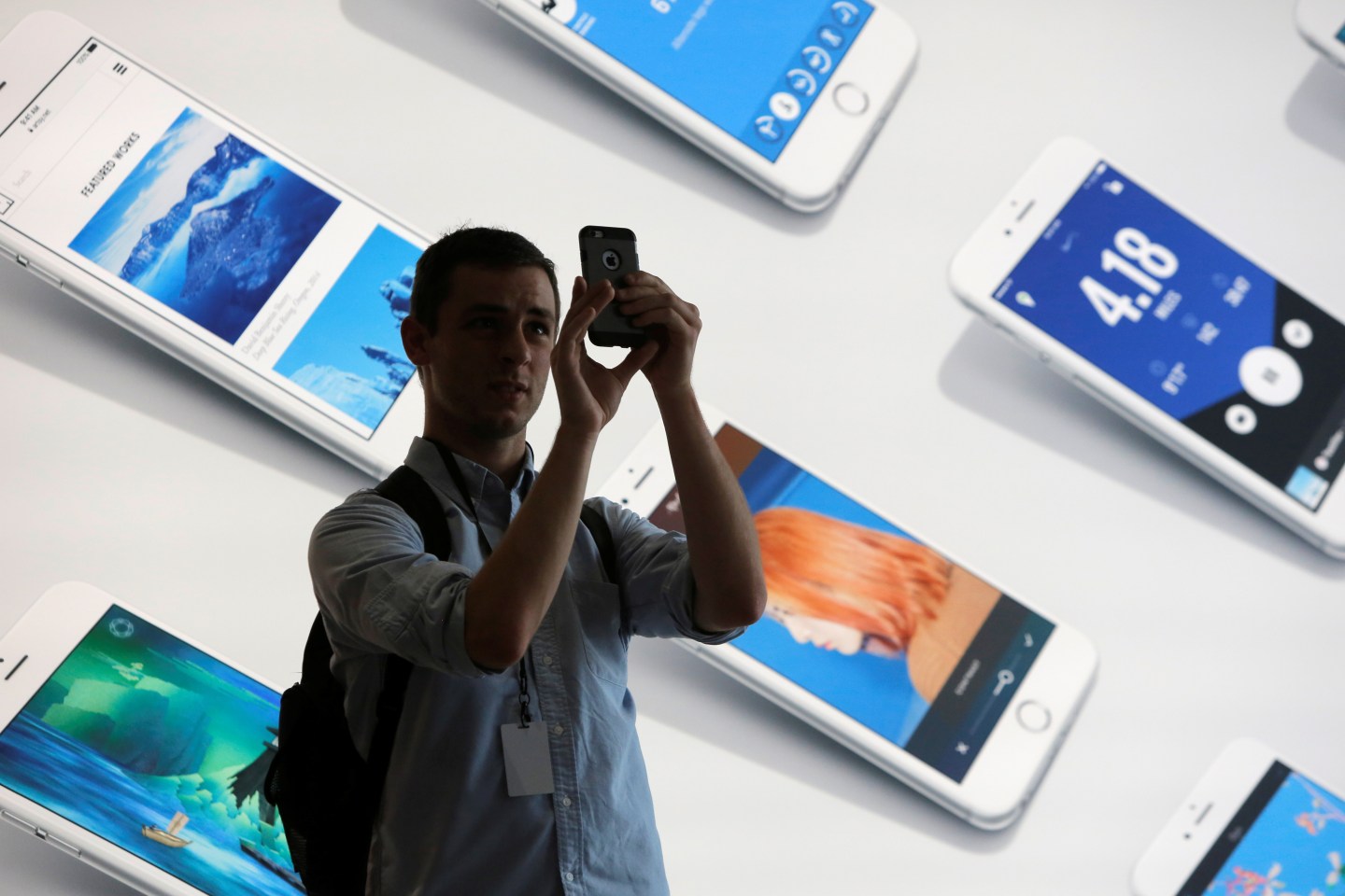 A man uses his iPhone during a preview event at the new Apple Store Williamsburg in Brooklyn, New York