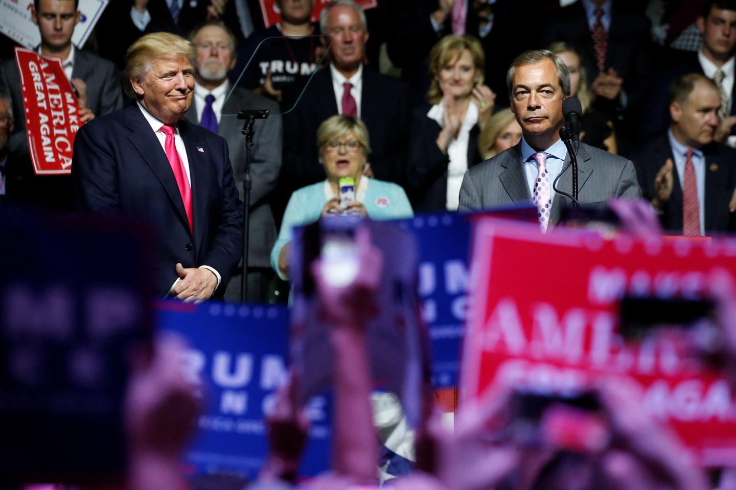 Republican presidential nominee Donald Trump watches as Member of the European Parliament Nigel Farage speaks at a campaign rally in Jackson