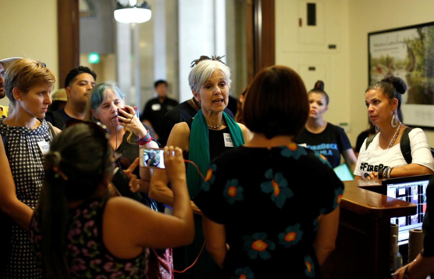 Green Party presidential candidate Stein and activists from Black Lives Matter speak with an employee as they attempt to meet with the mayor at City Hall in Los Angeles