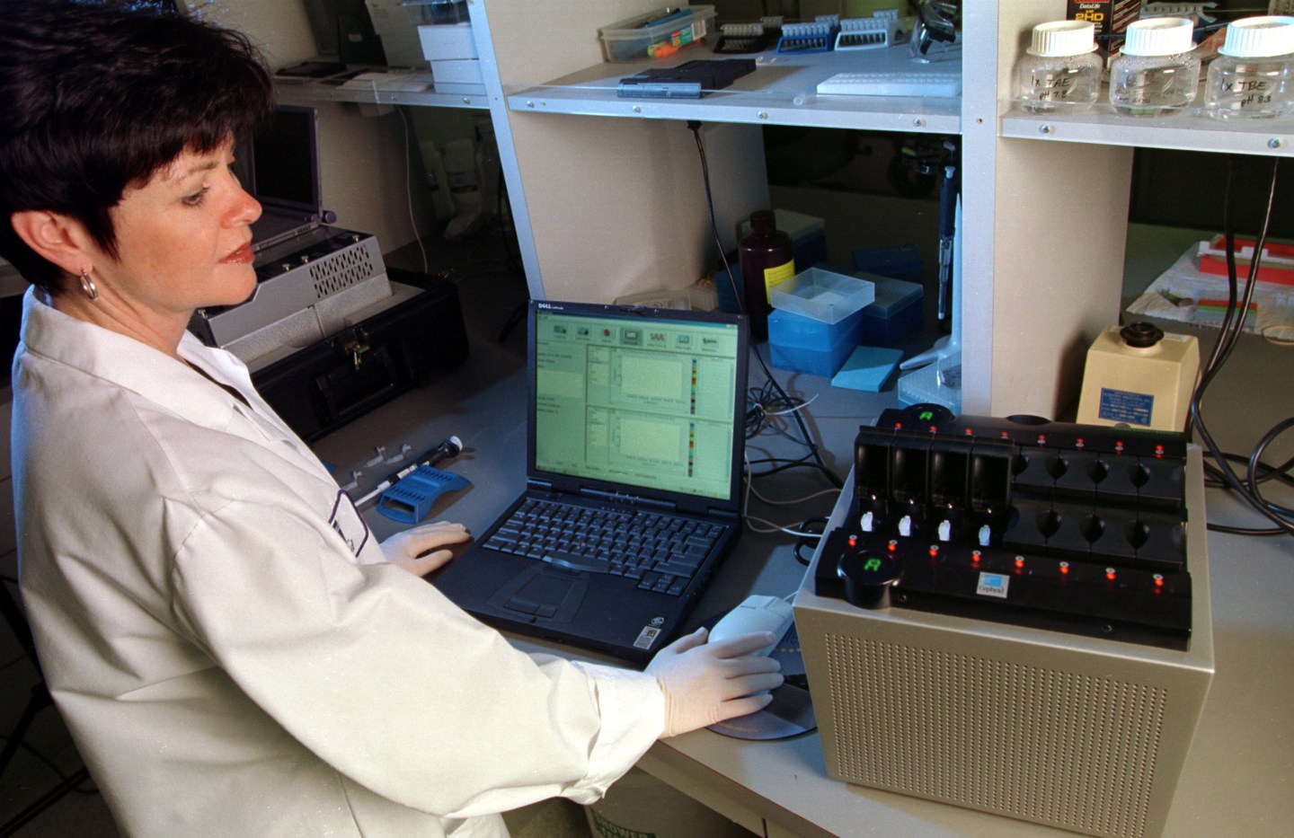 396384 02: Cepheid scientist Linda Western loads a Smart Cycler machine with samples October 24, 2001 at the company's Sunnyvale, California headquarters. The portable device uses DNA technology to detect biological pathogens, such as anthrax. Since the September 11 terrorist attacks, the company's stock has skyrocketed.