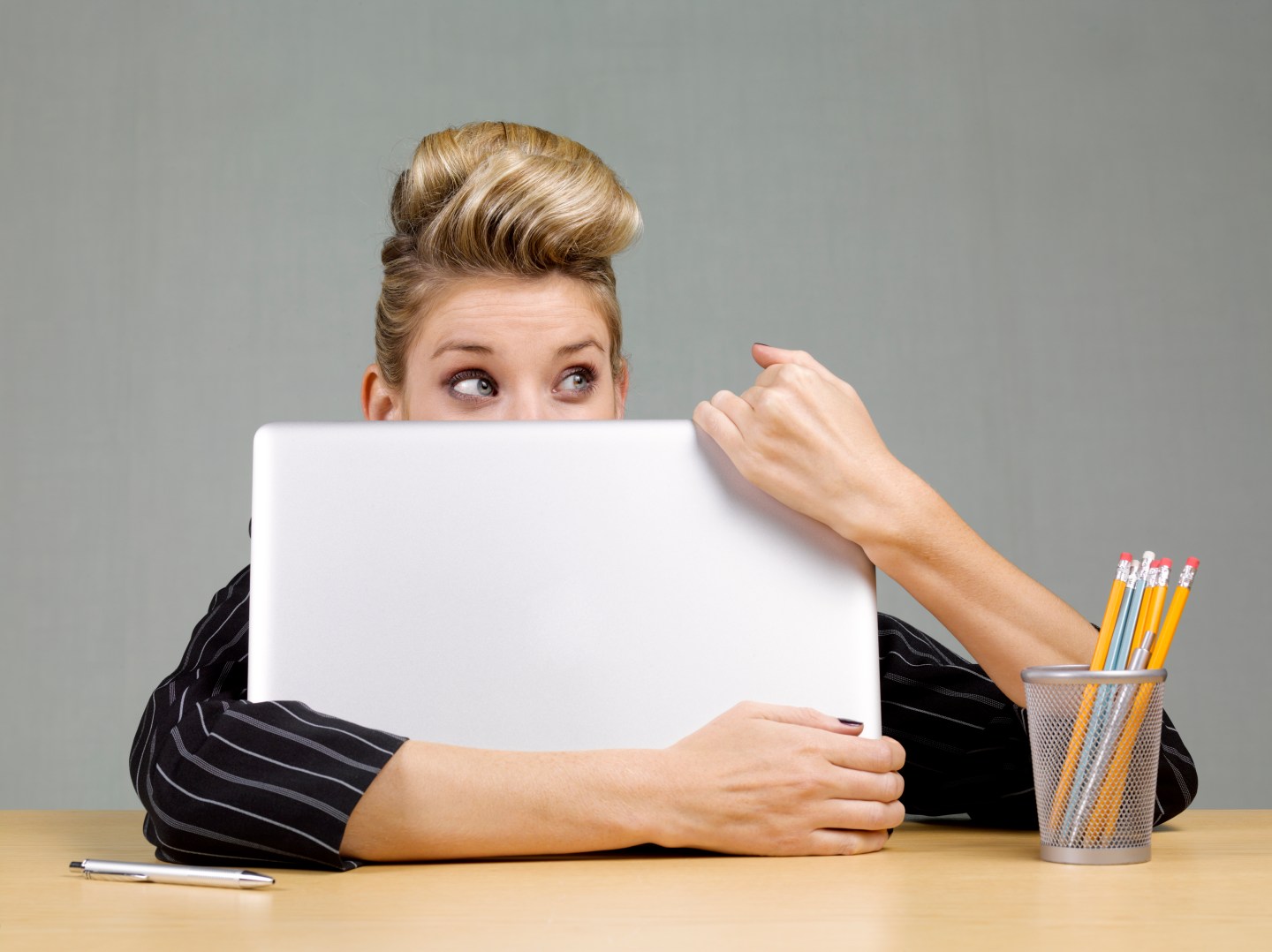 Guilty businesswoman behind laptop