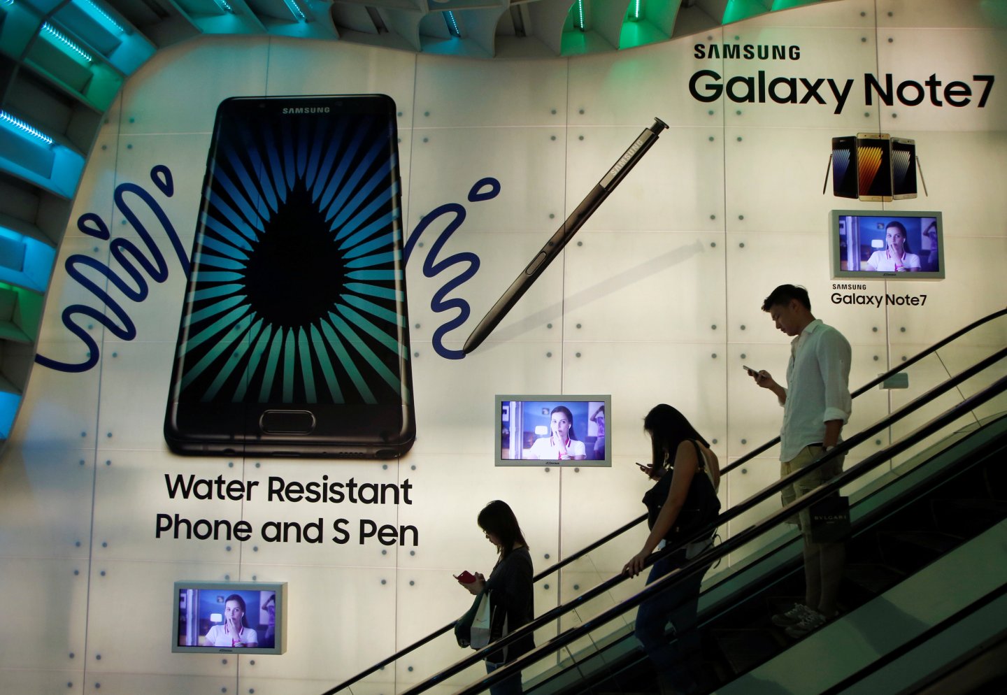 People pass a Samsung Note 7 advertisement in Singapore