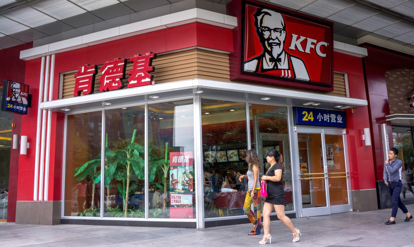 A KFC restaurant at a corner of street. KFC, McDonalds,