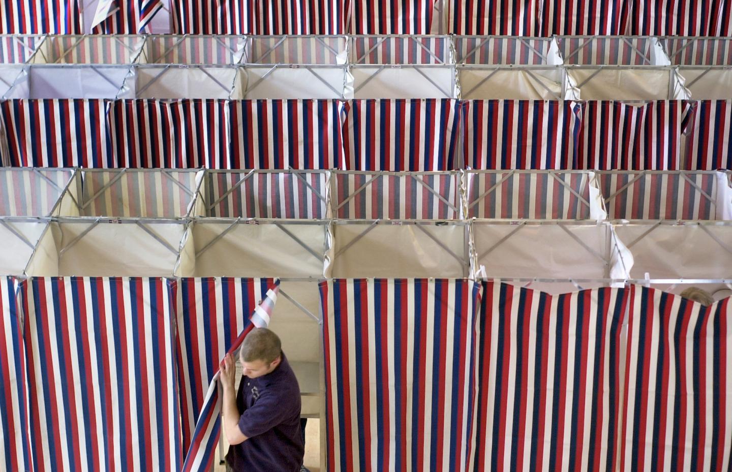 A man leaves a booth after voting at Kennebunk Town Hall on Tuesday. In addition to the state primar
