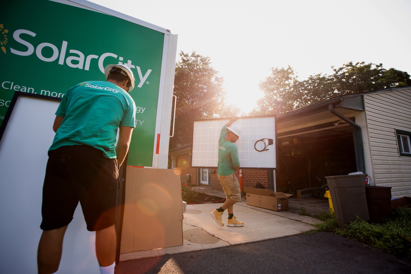 SolarCity employees unload solar panels from a truck during a home installation in New Jersey.
