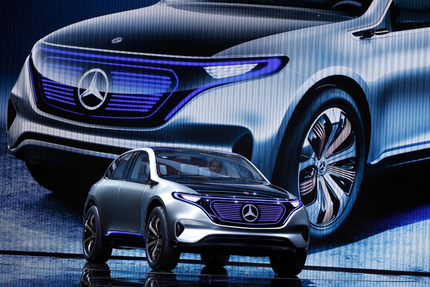 Dieter Zetsche, chief executive officer of Daimler AG, speaks on stage as he presents a new Mercedes-Benz Generation EQ concept sport-utility vehicle (SUV) during the 2016 press day of the Paris Motor Show.