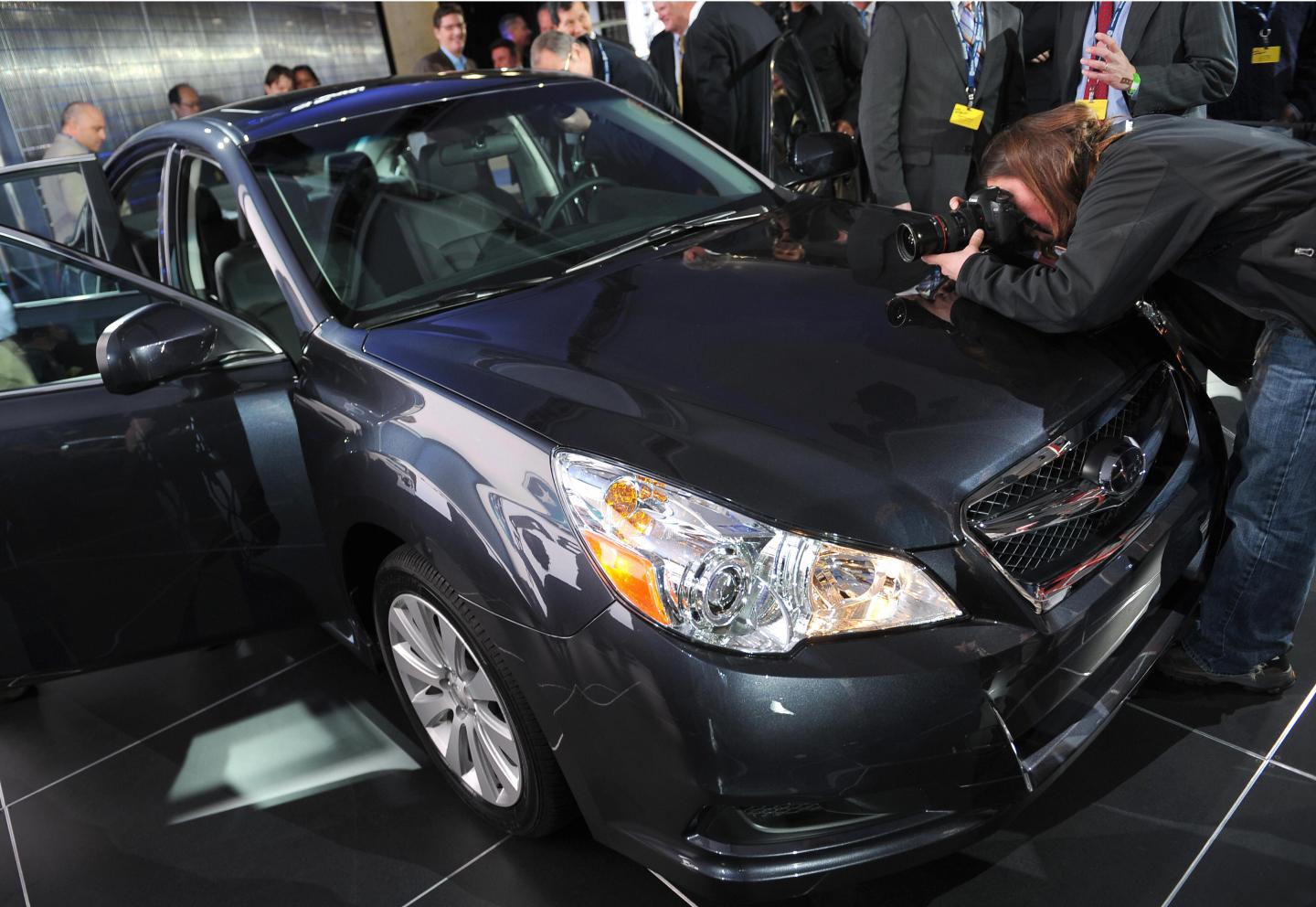 Members of the media inspect the 2010 Su