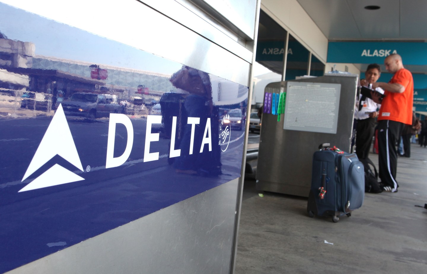 A Delta airlines customer checks his baggage at San Francisco International Airport.