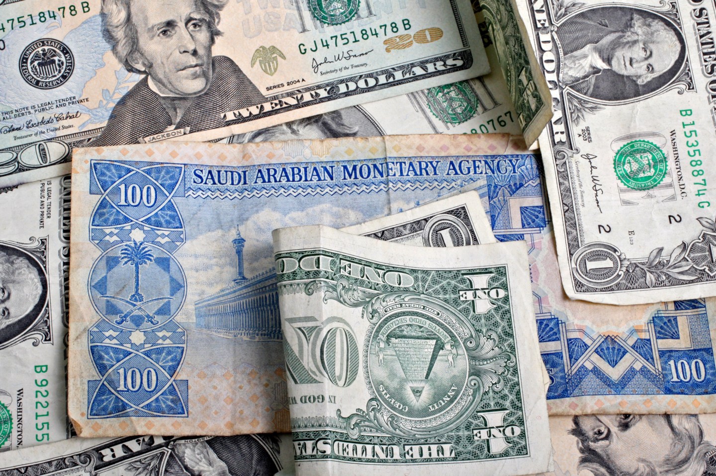 A Saudi Arabian one hundred riyal note and an assortment of