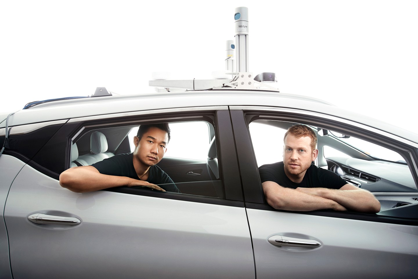 Cruise COO Daniel Kan (left) and CEO Kyle Vogt (right) in a Chevrolet self-driving-car prototype with a laser sensor on its roof. Kan and Vogt are now senior directors at General Motors, but Cruise retains considerable independence—part of an effort to preserve its fast-moving startup culture.