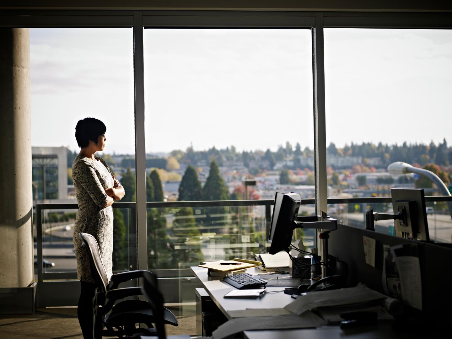 Businesswoman standing in office looking out