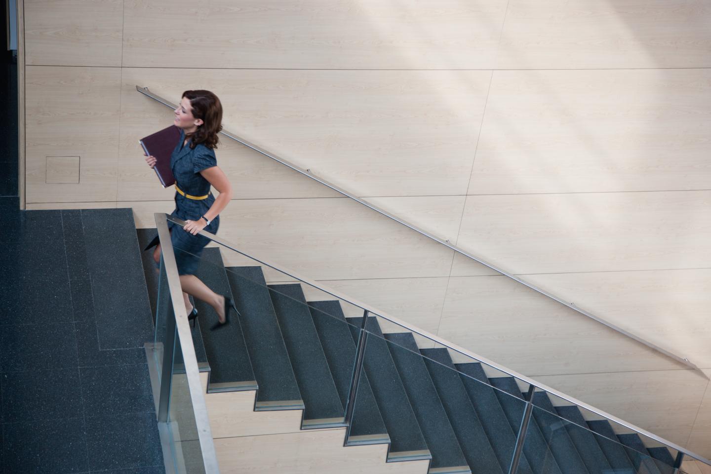 Businesswoman ascending office staircase