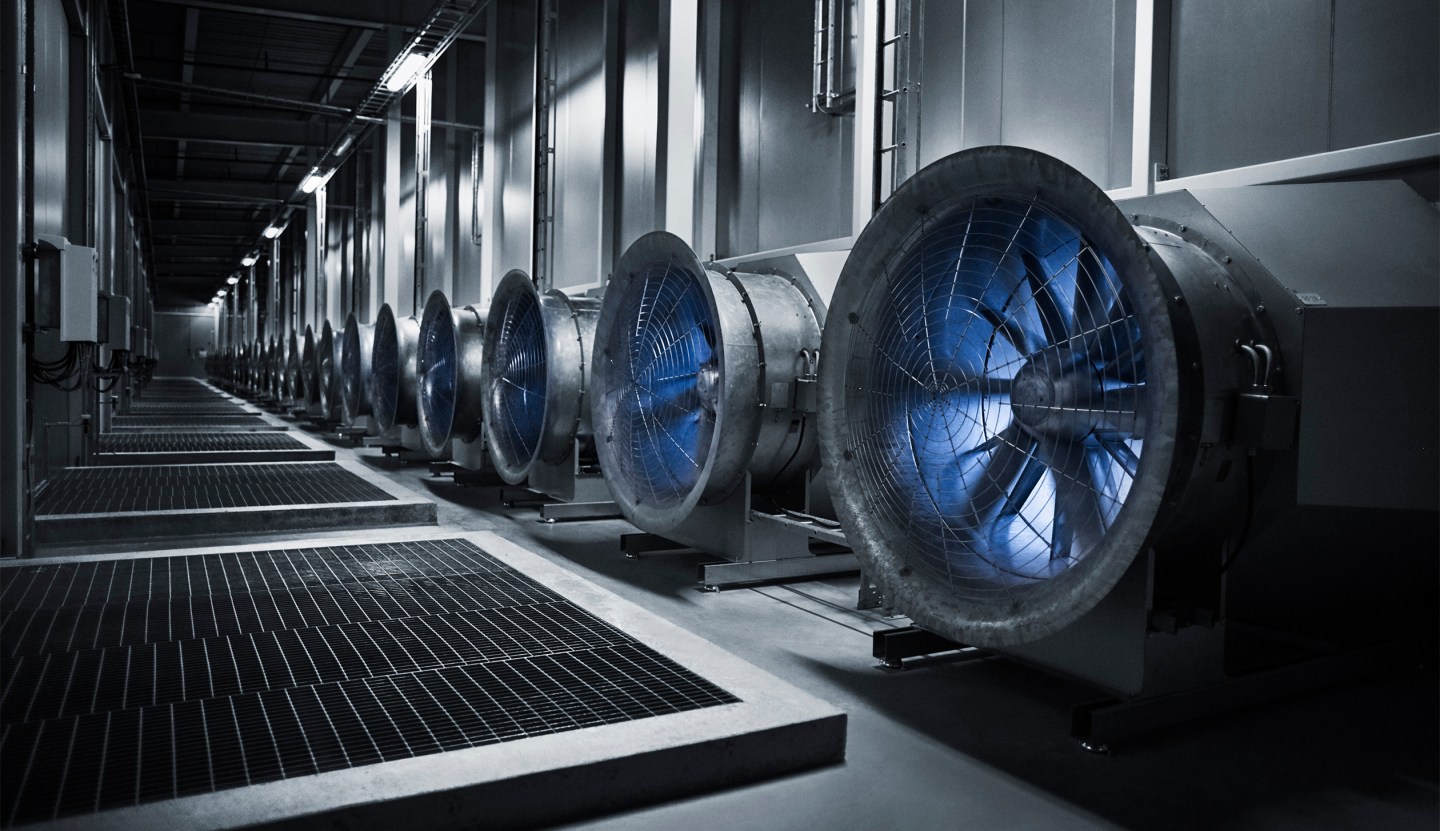 These enormous fans draw in the outside air to cool the servers in the data hall. In the winter, when temperatures plunge to -30 degrees the situation is reversed, and the heat from the servers warm the massive buildings.