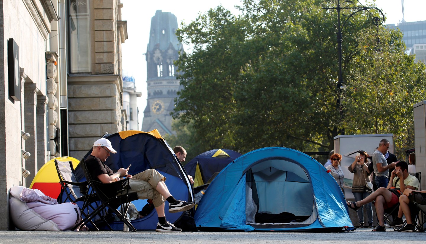 Customers wait beside their tents outside an Apple store to buy the newly released Apple iPhone 7 in Berlin