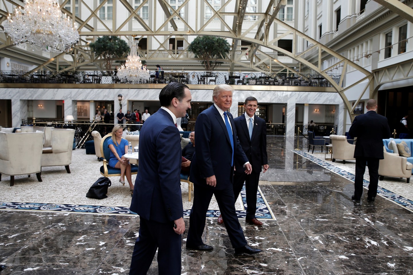 Republican presidential nominee Donald Trump walks through the atrium of his new Trump International Hotel in Washington